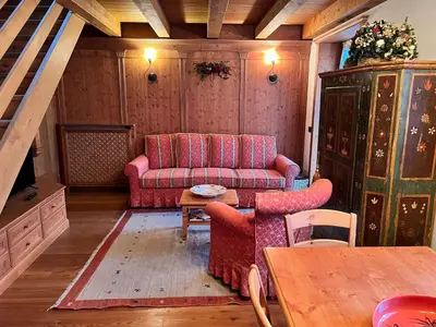 a living room with a couch and a table at Mansarda su due livelli nel cuore delle Dolomiti in San Vito di Cadore