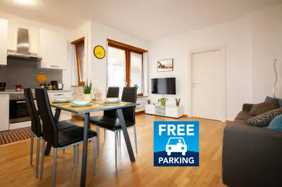 a living room with a table and chairs with a free parking sign at Tranquillo bilocale vicino al centro storico in Bolzano
