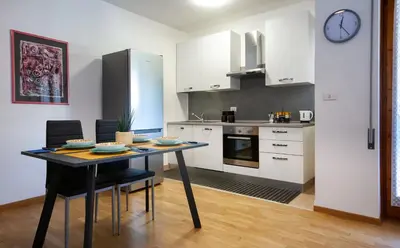 a kitchen with a table and chairs in a room at Tranquillo bilocale vicino al centro storico in Bolzano