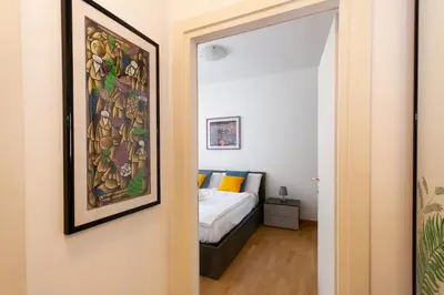 a bedroom with a bed and a painting on the wall at Tranquillo bilocale vicino al centro storico in Bolzano