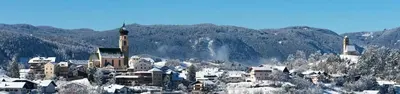 a town on top of a mountain with snow at Relax Home Fie' allo Sciliar - Alpe di Siusi Val Gardena in Fiè