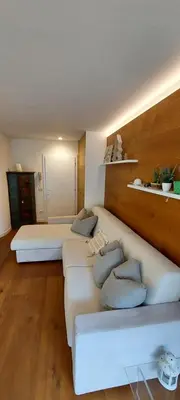 a living room with two beds and a couch at Relax Home Fie' allo Sciliar - Alpe di Siusi Val Gardena in Fiè