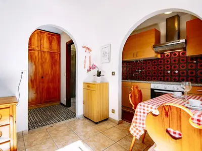 a kitchen with an archway and a table in a room at Apartment Cesa Minach-3 by Interhome in Alba di Canazei