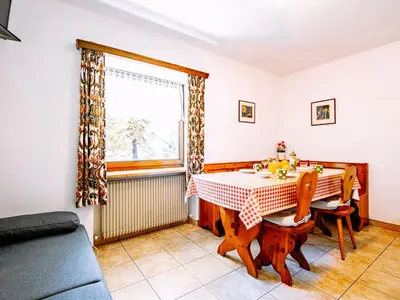a dining room with a table and a window at Apartment Cesa Minach-1 by Interhome in Alba di Canazei