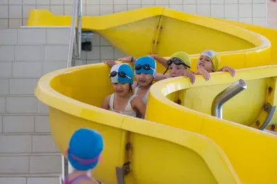 a group of children in a yellow plastic tub at Appartements Pedescin in Ortisei