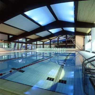 a large indoor swimming pool with a large ceiling at Appartements Pedescin in Ortisei