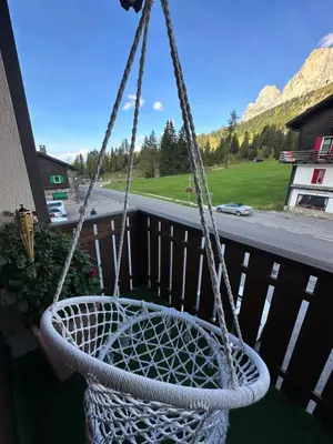 a balcony with lights and a view of a mountain at COSTALUNGAHOUSE TrekkingBikeSki selfcheck-in apartment in Carezza al Lago