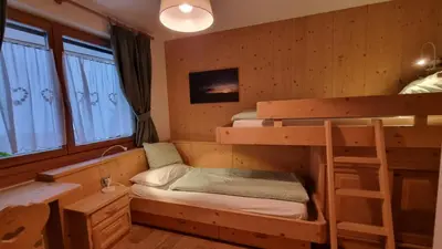 a room with two bunk beds and a sink at Alex in Campitello di Fassa