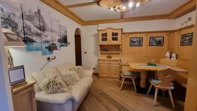 a living room with a couch and a desk at Alex in Campitello di Fassa