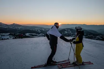 two people standing on top of a ski slope at Cyprianerhof Dolomit Resort in Tires