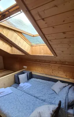a bed in a sauna with a roof at App. Lino nel cuore di Ortisei - casa dell'800 in Ortisei