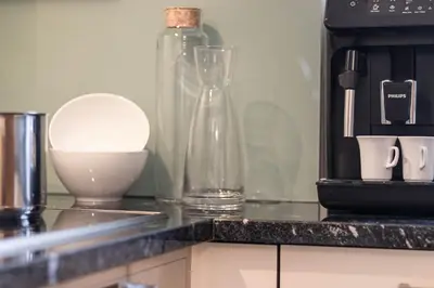 a kitchen counter with a coffee maker and a microwave at Appartment Lissi in Merano