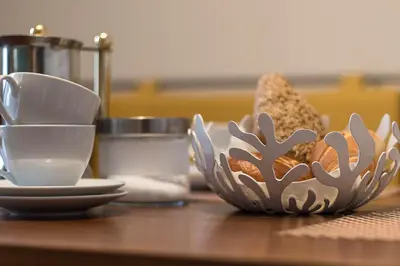 a table with plates and bowls on a table at Appartment Lissi in Merano