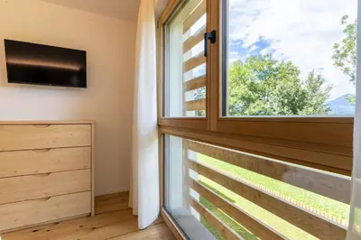 a room with a window and a tv at Casa Erika in San Lorenzo di Sebato