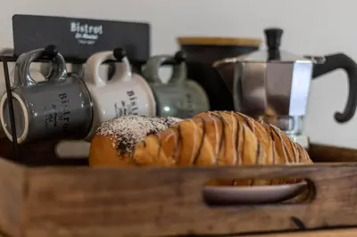 a wooden tray with bread and other items on a table at Casa Fiammetta in Brunico