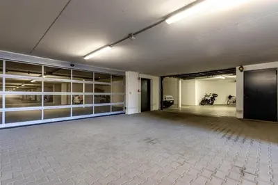 an empty garage with a motorcycle parked in it at Casa Fiammetta in Brunico
