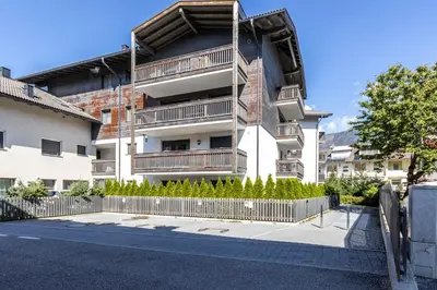 an apartment building with a fence in front of it at Casa Fiammetta in Brunico