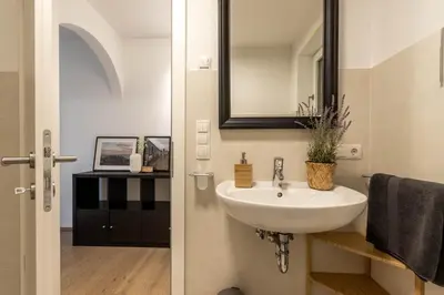 a bathroom with a sink and a mirror at Casa Fiammetta in Brunico