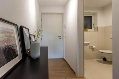 a bathroom with a vase sitting on a table at Casa Fiammetta in Brunico