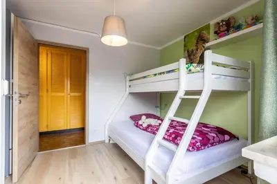 a bunk bed room with two bunk beds and a ladder at Casa Waldheim in Brunico