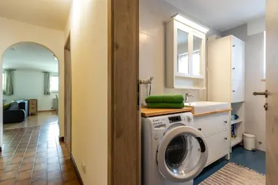 a kitchen with a washing machine in a room at Casa Waldheim in Brunico