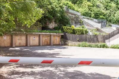 a gate in front of a fence and a driveway at Central Attic - Castle view in Brunico