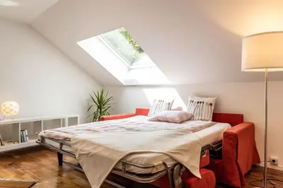 a bedroom with a bed and a skylight at Central Attic - Castle view in Brunico