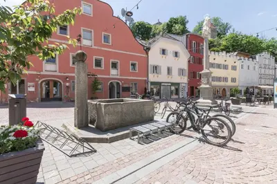 a group of bikes parked on a street with buildings at Central Attic - City view in Brunico