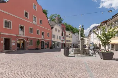 a cobblestone street in a town with buildings at Central Attic - City view in Brunico