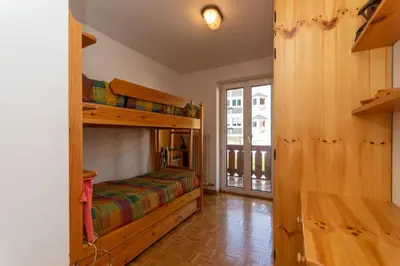 a bedroom with two bunk beds in a room at Casa Blue Sky in Moena