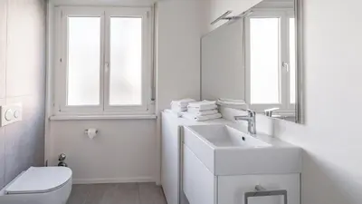 a bathroom with a sink and a toilet and a mirror at Italyescapes Maia in Merano