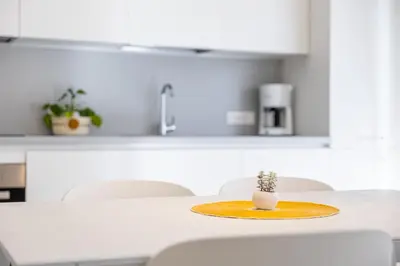 a table with a yellow plate with a cactus on it at Italyescapes Maia in Merano