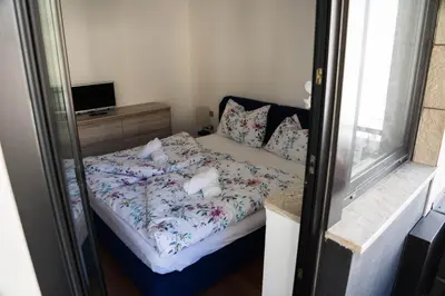 a small bedroom with a bed and a window at Casa Ricky in Bolzano