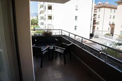 a balcony with a table and chairs and a view at Casa Ricky in Bolzano