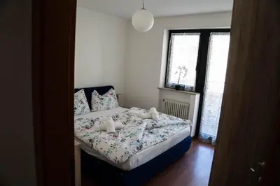 a bedroom with a bed with two teddy bears on it at Casa Ricky in Bolzano