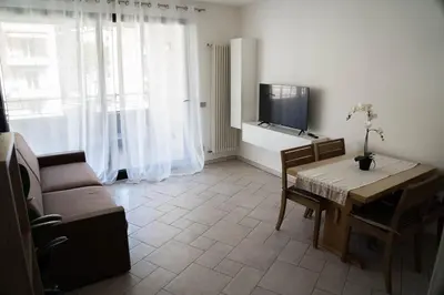 a living room with a table and a tv at Casa Ricky in Bolzano