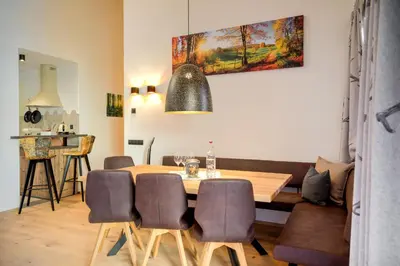 a dining room with a table and chairs at SchartnerAlm in Collalbo