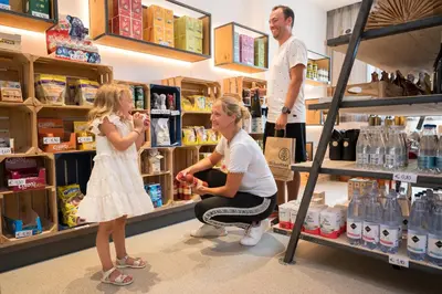 a woman feeding a little girl in a store at SchartnerAlm in Collalbo