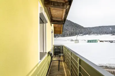 a balcony with a view of a snow covered field at Apartments Gasser in Rasun di Sopra
