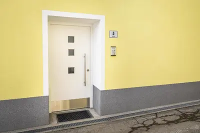 a white door on the side of a building at Apartments Gasser in Rasun di Sopra