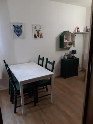 a dining room with a table and chairs in a room at La tana del Lupo in Falcade