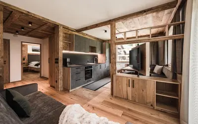 a living room with wooden walls and wooden flooring at Biohof Untergröber in Braies