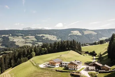 an aerial view of a house on a hill at Biohof Untergröber in Braies