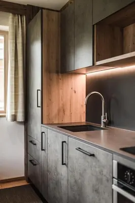 a kitchen with stainless steel cabinets and a sink at Biohof Untergröber in Braies