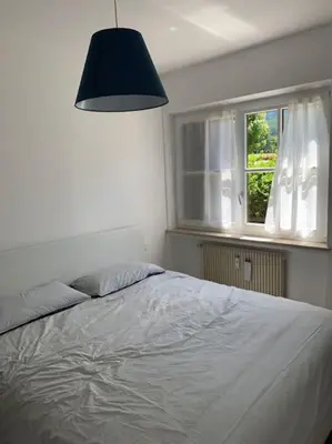 a bedroom with a large bed and a window at Sylvester Apartment in Riscone