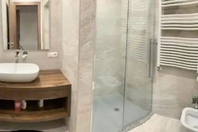 a bathroom with a sink and a glass shower at Sylvester Apartment in Riscone