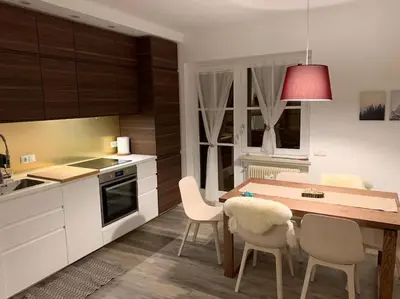 a kitchen with a table and chairs in a kitchen at Sylvester Apartment in Riscone