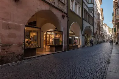 a cobblestone street with shops on the side of a building at Lauben Flat Bolzano in Bolzano