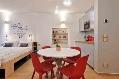 a room with a table and chairs and a bed at Lauben Flat Bolzano in Bolzano