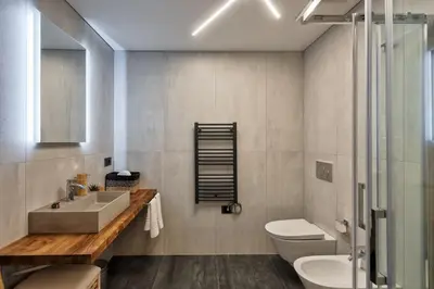 a bathroom with a sink and a toilet and a shower at Lauben Flat Bolzano in Bolzano